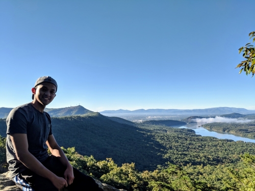 A man laying on top of a mountain